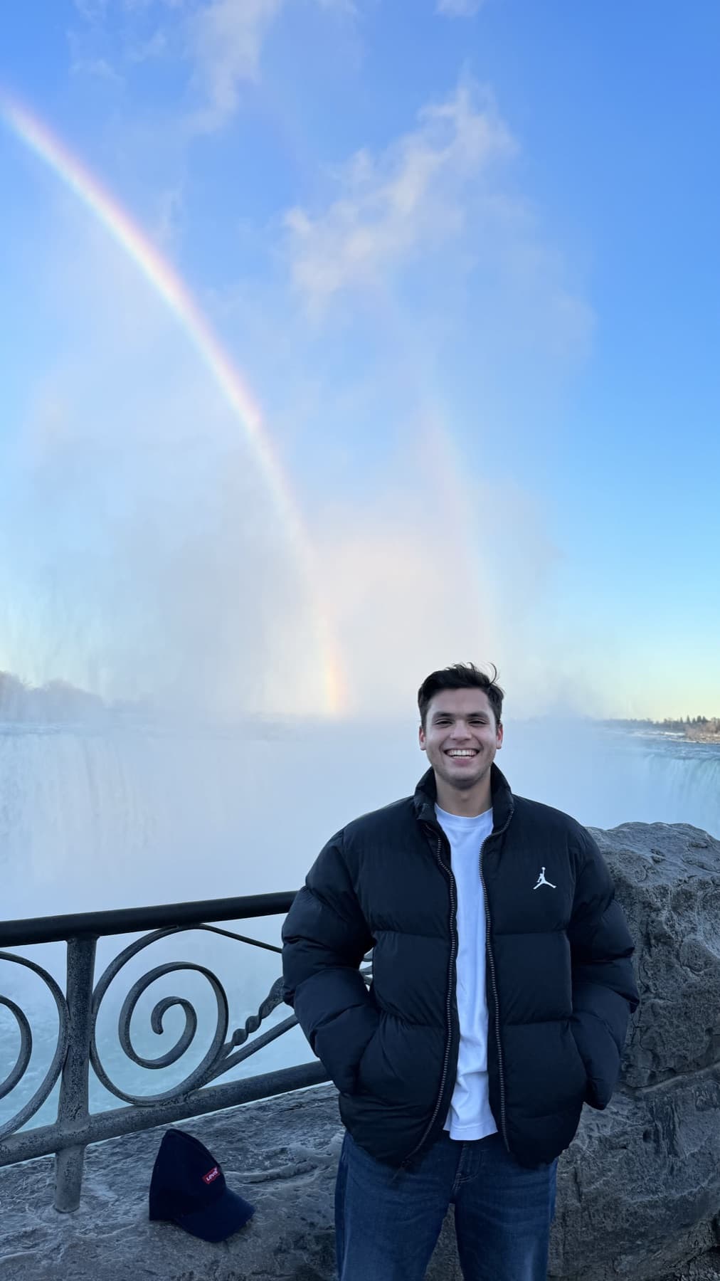 Manan at Niagara Falls beneath a rainbow